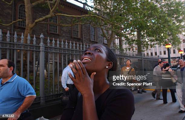 Woman reacts in terror as she looks up to see the World Trade Center go up in flames September 11, 2001 in New York City after two airplanes slammed...