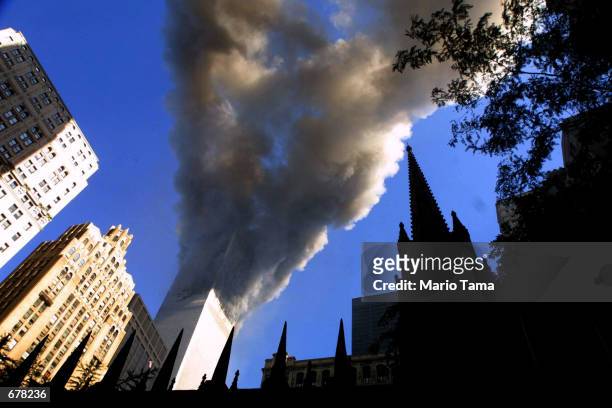 Smoke spews from a tower of the World Trade Center September 11, 2001 after two hijacked airplanes hit the twin towers in an alleged terrorist attack...