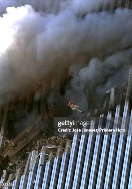 Man leaps to his death from a fire and smoke filled Tower One of the World Trade Center September 11, 2001 in New York City after terrorists crashed...