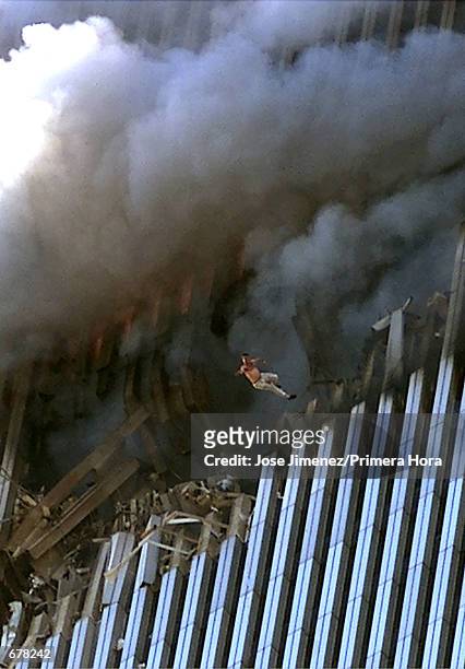 Man leaps to his death from a fire and smoke filled Tower One of the World Trade Center September 11, 2001 in New York City after terrorists crashed...