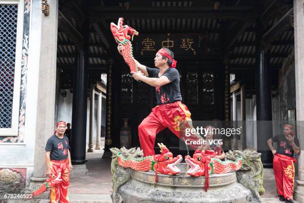 Artists perform during the Drunken Dragon Parade to celebrate Buddha's birthday on May 3, 2017 in Zhongshan, Guangdong Province of China. Folk...