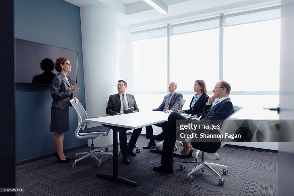 Businesswoman leading group meeting in office