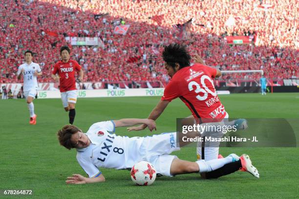 Shinzo Koroki of Urawa Red Diamonds and Shoma Doi of Kashima Antlers compete for the ball during the J.League J1 match between Urawa Red Diamonds and...