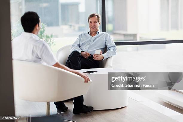 men having conversation in meeting room lounge - chaise lounge bildbanksfoton och bilder