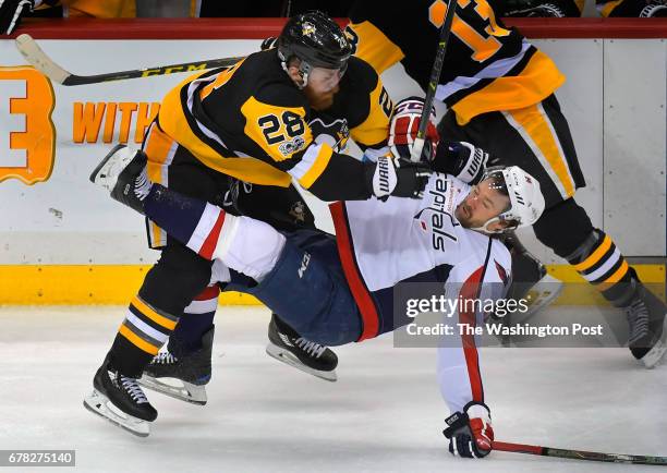 Pittsburgh defenseman Ian Cole , left, send Washington right wing Justin Williams to the ice hard in the 3rd period during the Pittsburgh Penguins...