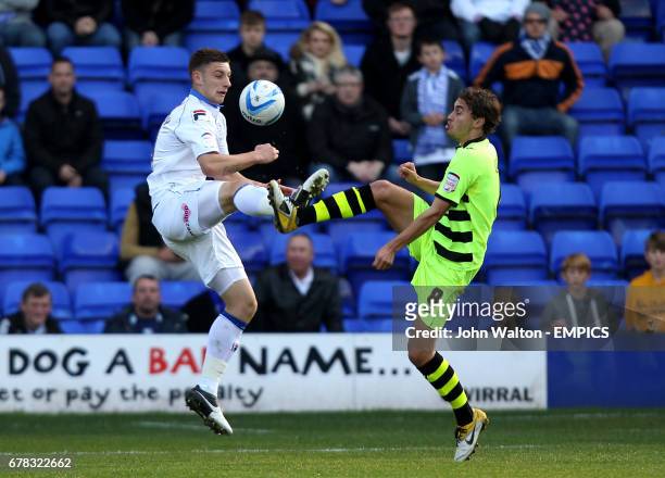 Tranmere Rovers' Jake Cassidy and Yeovil Town's Ed Upson battle for possession of the ball in the air