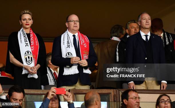 Prince Albert II of Monaco and his wife Charlene, Princess of Monaco, and Monaco's Russian President Dmitriy Rybolovlev attend the UEFA Champions...