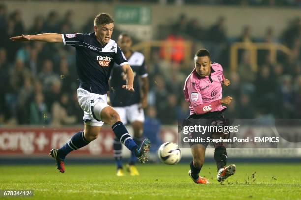 Birmingham City's Nathan Redmond gets a shot on goal despite the attention of Millwall's Shane Lowry