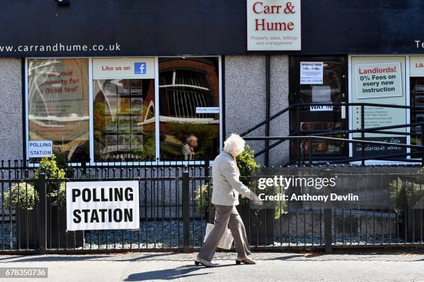 Woman walks past a polling station at Carr & Hume estate agents in Swinton during the Manchester Mayoral election on May 4, 2017 in Manchester,...