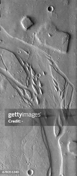 This NASA Mars Odyssey THEMIS image obtained 22 June 2003 shows typical erosional islands and depositional features southwest of the volcano Elysium...