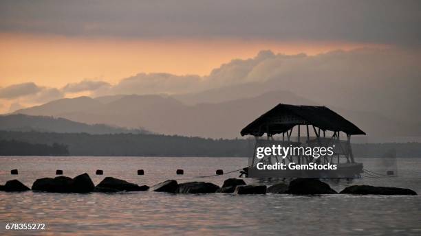Silhouette of a floating cottage at sunrise, Davao Oriental, Philippines