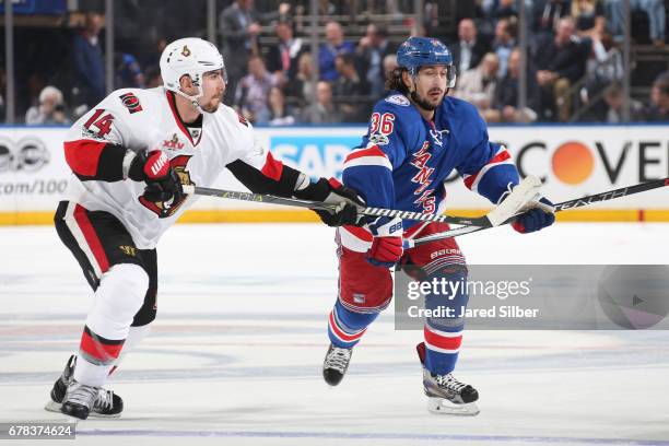 Mats Zuccarello of the New York Rangers skates against Alexandre Burrows of the Ottawa Senators in Game Three of the Eastern Conference Second Round...