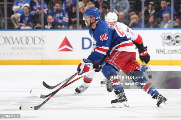 Michael Grabner of the New York Rangers skates with the puck against the Ottawa Senators in Game Three of the Eastern Conference Second Round during...