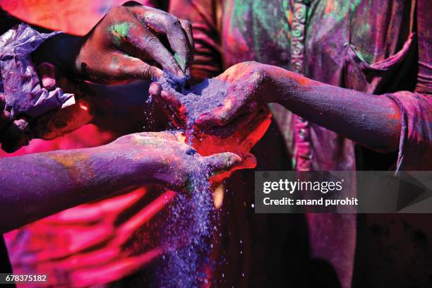 holi, festival of colours - colour powder is on the hands - holi hands stock pictures, royalty-free photos & images