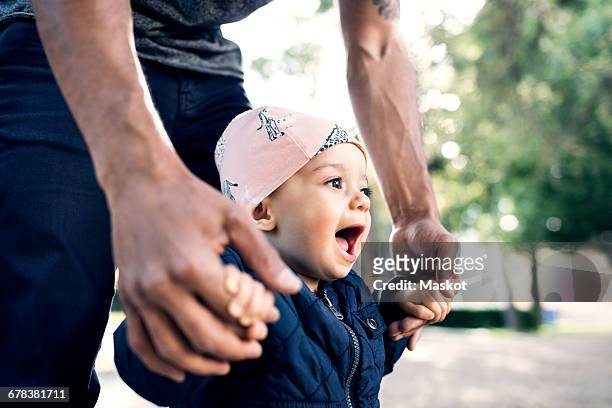 midsection of father walking with toddler at park - arab family outdoor bildbanksfoton och bilder