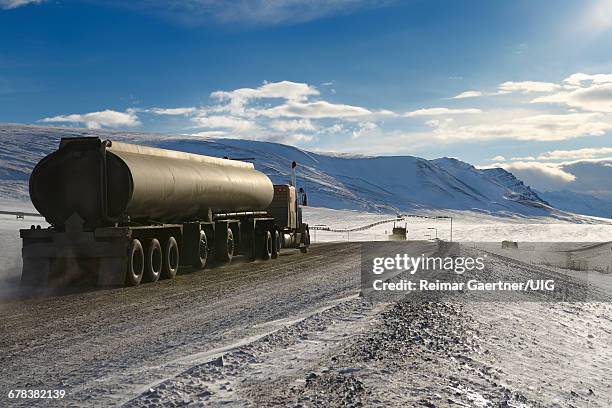 tankers and trucks driving the dalton highway - arctic oil stock pictures, royalty-free photos & images