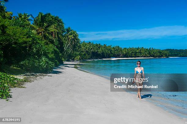 woman walking on a a white sand beach, nanuya lailai island, the blue lagoon, yasawas, fiji, south pacific, pacific - yasawa island group stock pictures, royalty-free photos & images