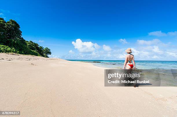 woman walking on a white sand beach on a little islet in haapai, haapai islands, tonga, south pacific, pacific - haapai islands stock pictures, royalty-free photos & images