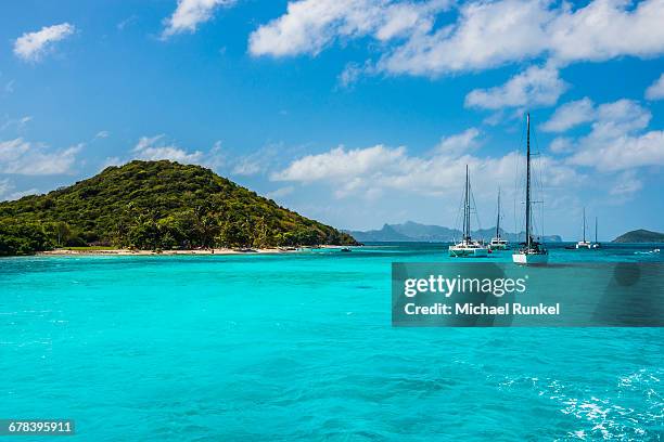 sailing boats anchoring in the tobago cays, the grenadines, st. vincent and the grenadines, windward islands, west indies, caribbean, central america - tobago cays stock pictures, royalty-free photos & images