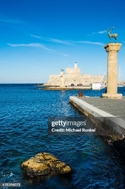 the deers, symbol of the city, at the entrance to mandraki harbour, the medieval old town of the city of rhodes, unesco world heritage site, rhodes, dodecanese islands, greek islands, greece, europe - rhodes old town stock pictures, royalty-free photos & images