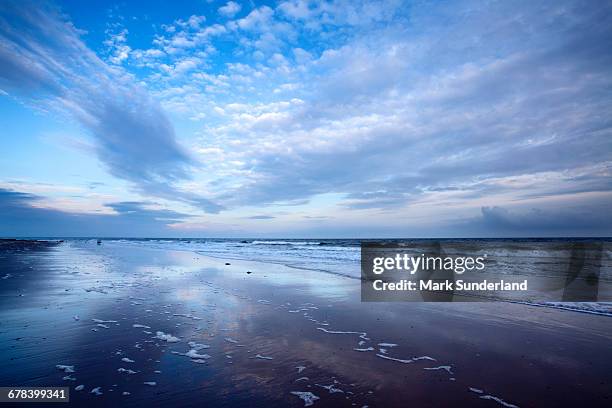cloud reflections at twilight on alnmouth beach, northumberland, england, united kingdom, europe - alnmouth beach ストックフォトと画像
