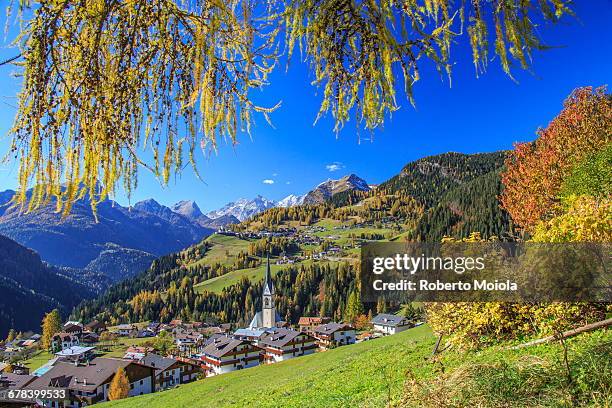 the villages of selva di cadore and colle santa lucia, in the dolomitic cadore region, surrounded by yellow larches in autumn, veneto, italy, europe - colle santa lucia stock pictures, royalty-free photos & images