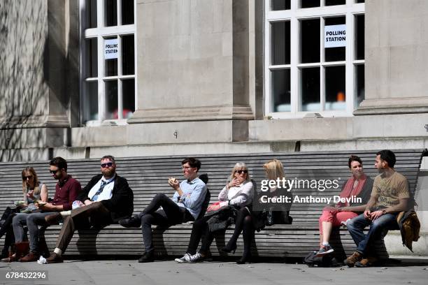 Members of the public enjoy the warm weather outside a Polling station at Manchester Central Library during the Manchester Mayoral election on May 4,...