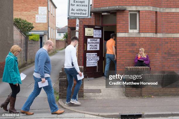 Voters arrive at a polling station during the local council elections on May 4, 2017 in Birchgrove, Cardiff, Wales. A total of 4,851 council seats...