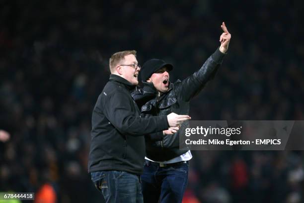 Bradford City fans celebrate on the pitch