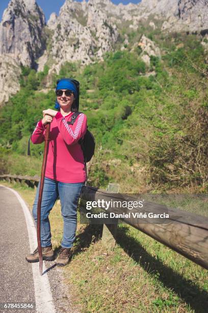 caucasian woman hiking on a road - picos de europe stock pictures, royalty-free photos & images