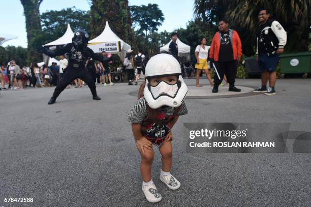 Young fan with a Stormtrooper mask looks on during a festival marking Star Wars Day, celebrated annually by fans of the film franchise for the...