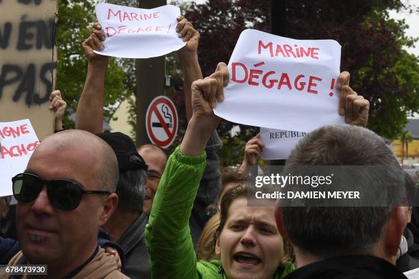 People prostest against French presidential election candidate for the far-right Front National party, during her visit to a transport company in...