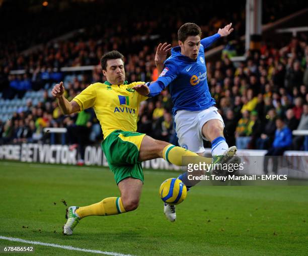 Peterborough United's Tommy Rowe tackled by Norwich City's Russell Martin