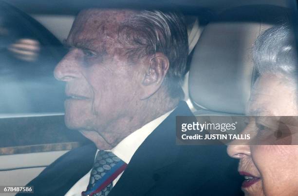 Britain's Queen Elizabeth II and Britain's Prince Philip, Duke of Edinburgh arrive back at Buckingham Palace in London on May 4 after attending a...