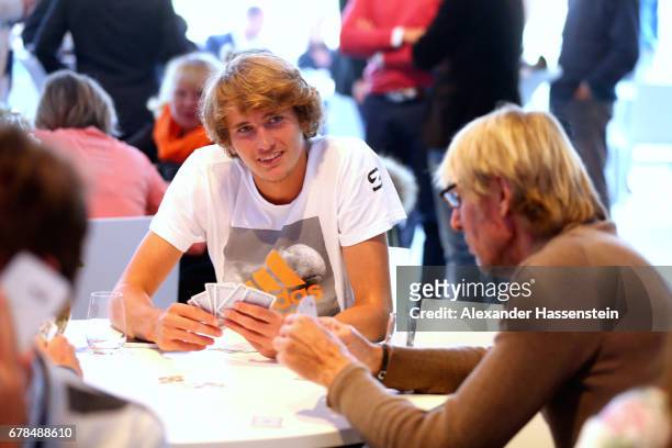 Alexander Zverev plays card with Carlo Thraenhardt during the 102. BMW Open by FWU at Iphitos tennis club on May 4, 2017 in Munich, Germany.