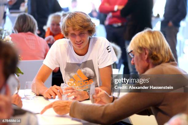 Alexander Zverev plays card with Carlo Thraenhardt during the 102. BMW Open by FWU at Iphitos tennis club on May 4, 2017 in Munich, Germany.