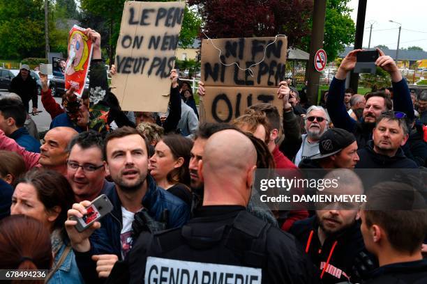 People hold up signs that read, 'Le Pen we don't want you' and 'No FN, No Le Pen, Out' as they rally to protest against French presidential election...