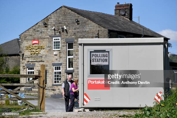 Couple cast their votes at a polling station beside Roaches Lock public house in Mossley, Tameside, during the Manchester Mayoral election on May 4,...