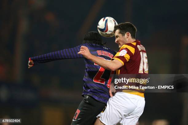 Arsenal's Yao Gervinho and Bradford City's Carl McHugh battle for the ball in the air