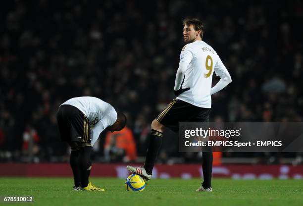 Swansea City's Miguel Michu looks dejected as he prepares to re-start with team mate Wayne Routledge