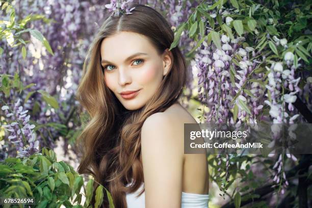 beautiful girl on the background of spring bush - long hair nature stock pictures, royalty-free photos & images