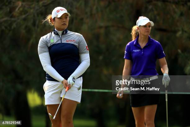 Ariya Jutanugarn of Thailand watches her shot on the third tee as Amy Anderson of the United States looks on during the first round of the...
