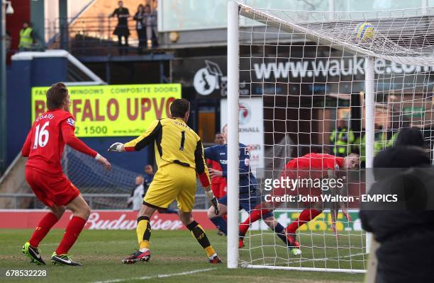 Liverpool goalkeeper Brad Jones is helpless to stop Oldham Athletic's Matt Smith scoring their first goal of the game