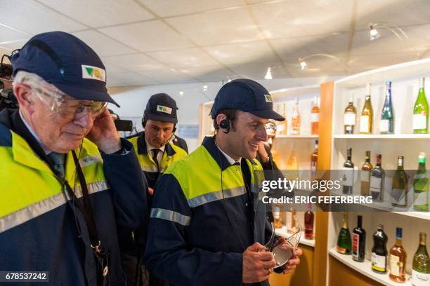French presidential election candidate for the En Marche ! movement Emmanuel Macron and Jean-Pierre Floris , CEO of glass-making company Verallia,...