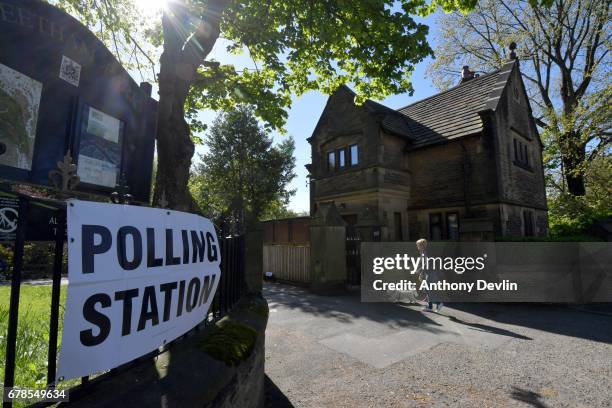 Woman arrives with her dog at a polling station in Stalybridge, Tameside, during the Manchester Mayoral election on May 4, 2017 in Manchester,...