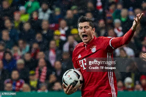 Robert Lewandowski of Bayern Munich ist mit einer Entscheidung des Referee assistenten nich gestures during the German Cup semi final soccer match...