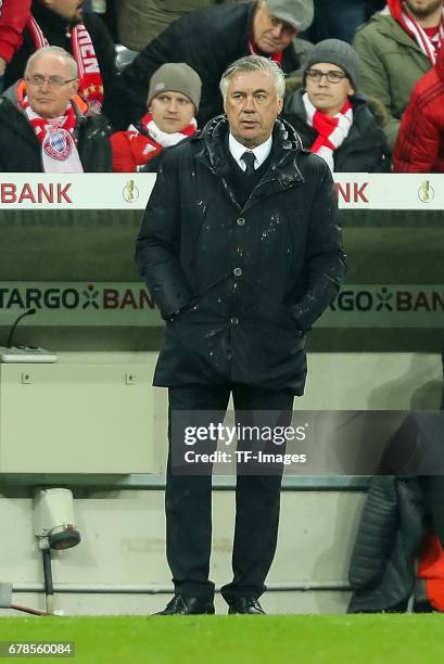 Head coach Carlo Ancelotti of Bayern Munich looks on during the German Cup semi final soccer match between FC Bayern Munich and Borussia Dortmund at...