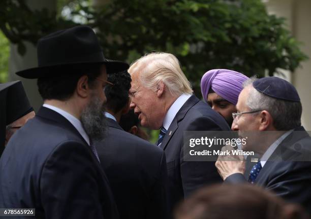 President Donald Trump greets clergy members after signing an Executive Order on Promoting Free Speech and Religious Liberty, during a National Day...