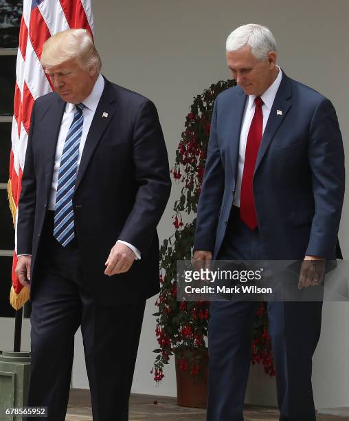 President Donald Trump and Vice President Mike Pence walk into the Rose Garden to attend a National Day of Prayer event , at the White House, on May...