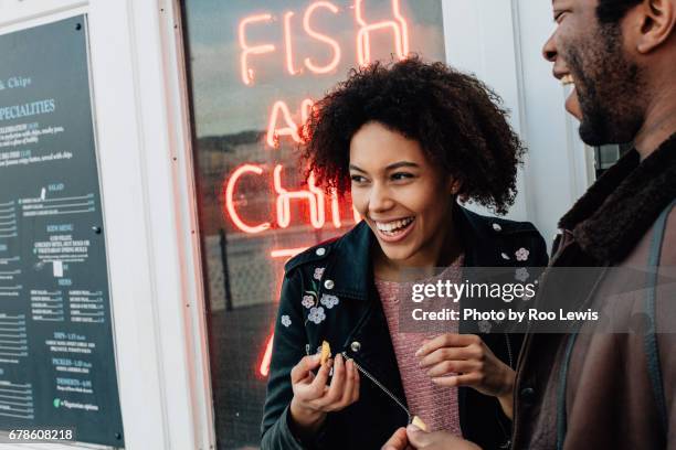 seaside couples - black man eating stock pictures, royalty-free photos & images